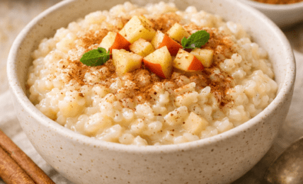 a bowl of rice pudding with apples and cinnamon